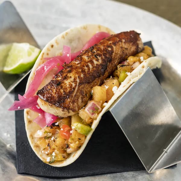 Vida Taco Bar's fish taco with grilled fish, pineapple salsa, and pickled red onions.